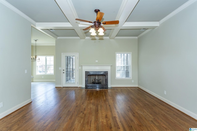 unfurnished living room with dark hardwood / wood-style floors, crown molding, ceiling fan with notable chandelier, and coffered ceiling