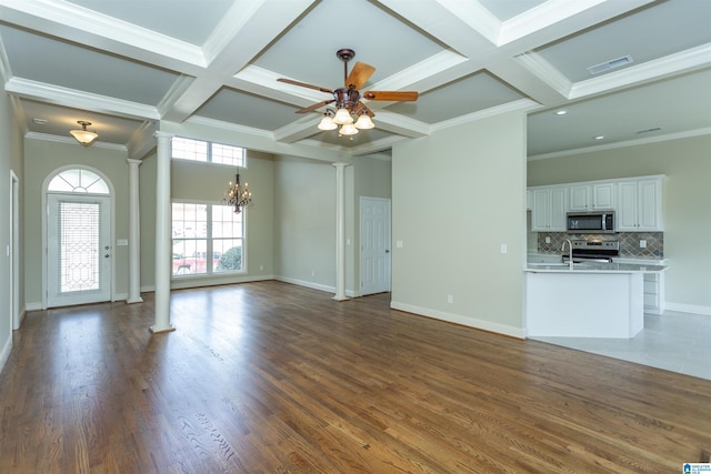 unfurnished living room featuring dark hardwood / wood-style floors, ornate columns, crown molding, and coffered ceiling