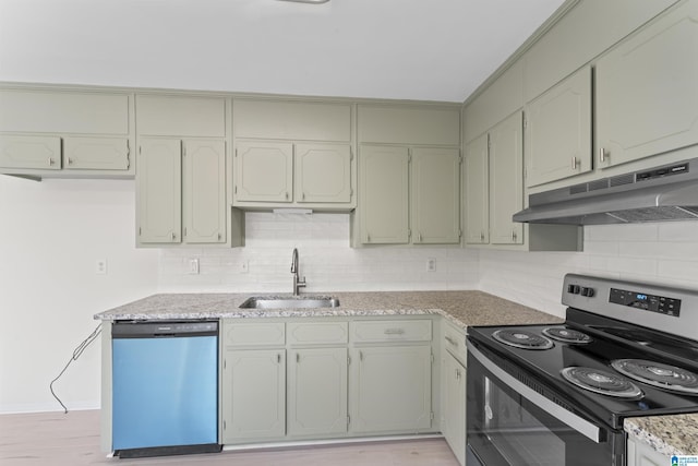 kitchen with sink, light hardwood / wood-style flooring, decorative backsplash, light stone counters, and stainless steel appliances