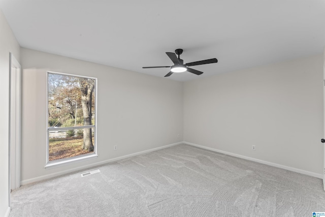 carpeted spare room with ceiling fan