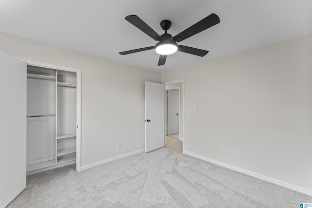 unfurnished bedroom with light carpet, a closet, and ceiling fan