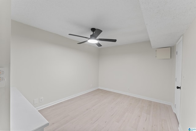 unfurnished room with ceiling fan, light hardwood / wood-style flooring, and a textured ceiling