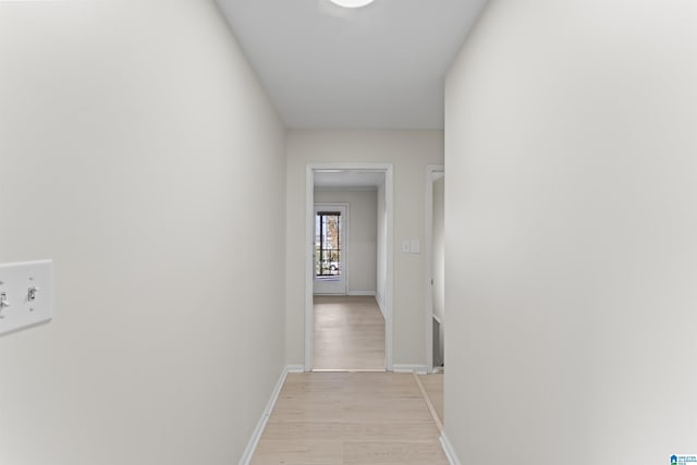 corridor with light hardwood / wood-style floors