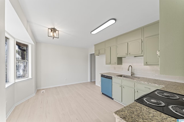 kitchen with light stone countertops, dishwasher, sink, light hardwood / wood-style flooring, and backsplash