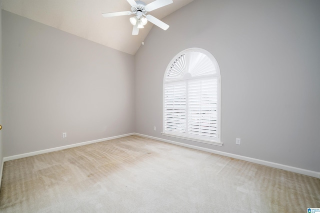 spare room with ceiling fan, light colored carpet, and high vaulted ceiling