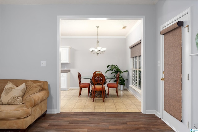 dining space with a chandelier, hardwood / wood-style flooring, and ornamental molding