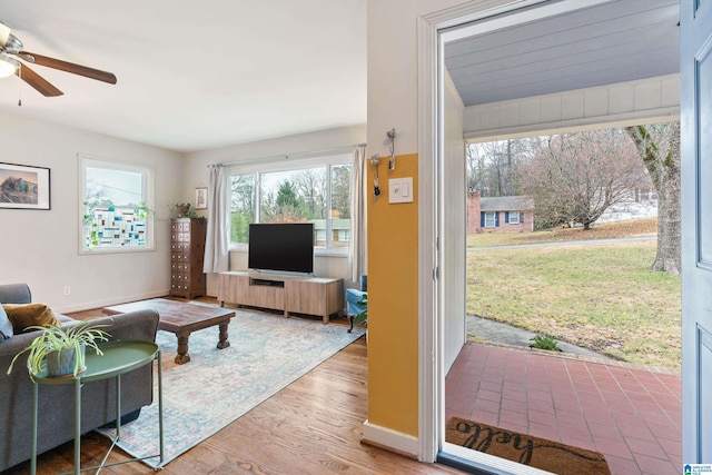 living room featuring hardwood / wood-style floors and ceiling fan