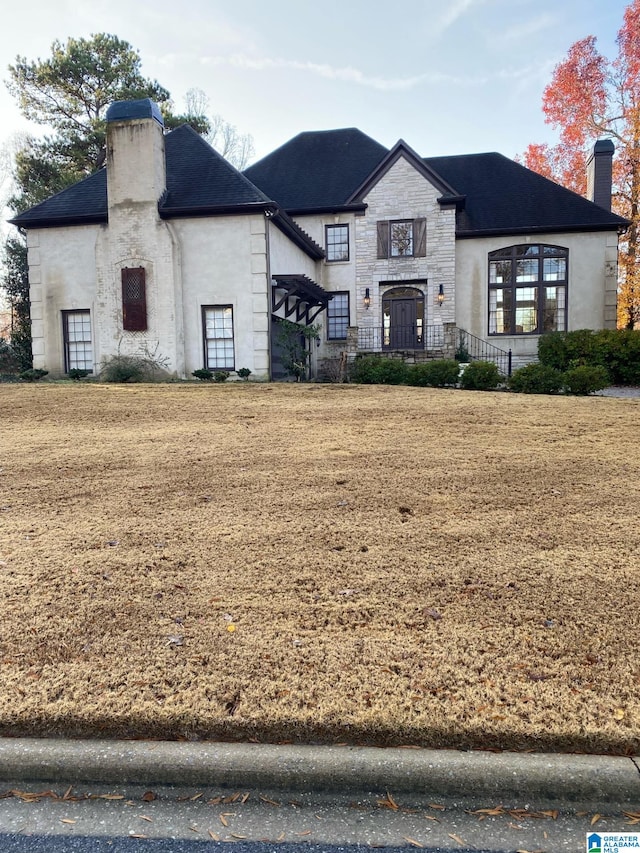 french country style house with a front yard