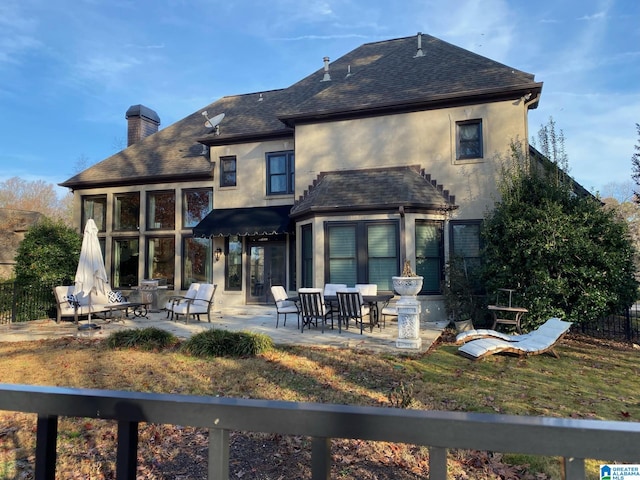 rear view of property featuring a patio area