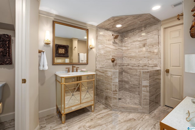 bathroom with vanity and a tile shower