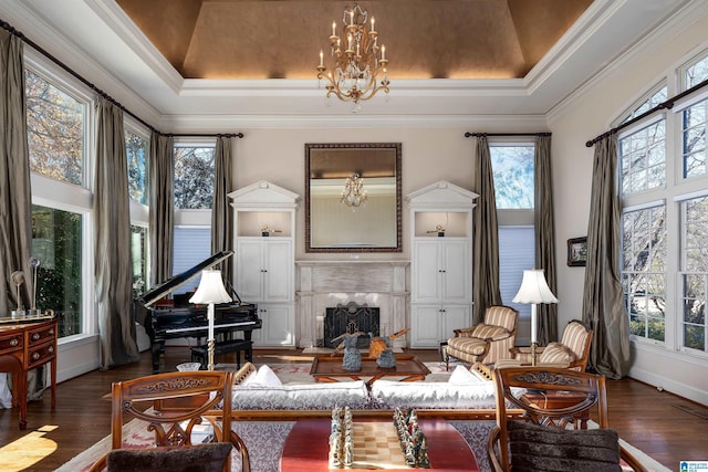 interior space with crown molding, a tray ceiling, and dark wood-type flooring