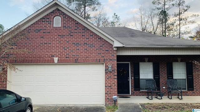 single story home featuring a porch and a garage