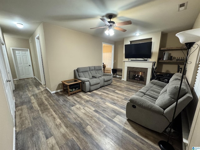 living room featuring wood-type flooring and ceiling fan