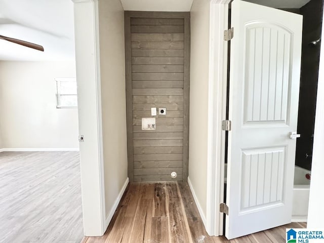 laundry area featuring electric dryer hookup, ceiling fan, and hardwood / wood-style flooring