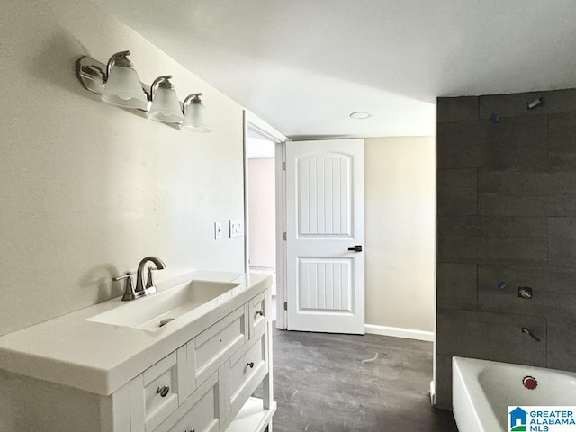 bathroom featuring vanity, a bathtub, and concrete floors