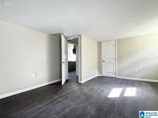 unfurnished bedroom with dark hardwood / wood-style floors