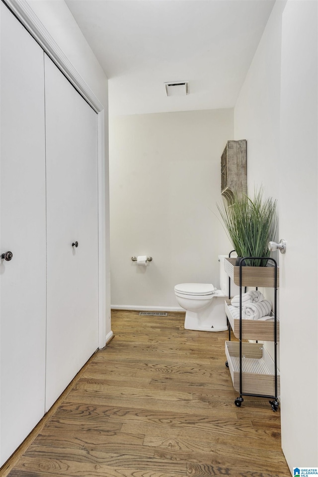 bathroom featuring toilet and hardwood / wood-style flooring