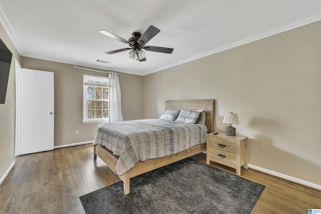 bedroom featuring ceiling fan, dark hardwood / wood-style floors, and ornamental molding