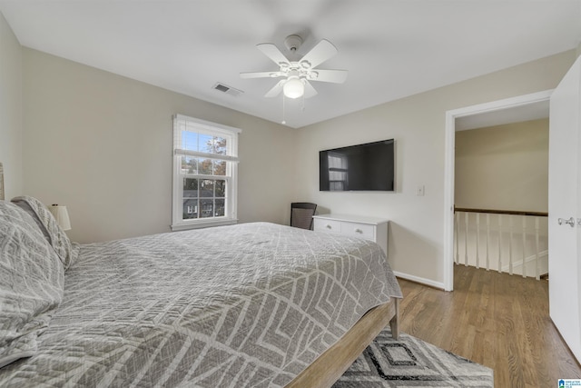 bedroom with wood-type flooring and ceiling fan