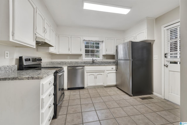 kitchen with white cabinets, sink, stainless steel appliances, and light tile patterned flooring