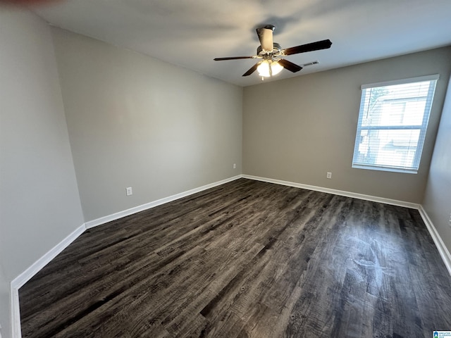 spare room featuring ceiling fan and dark wood-type flooring