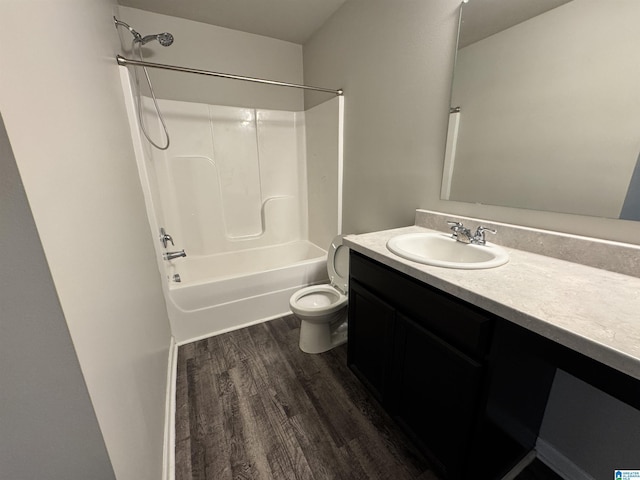 full bathroom featuring hardwood / wood-style floors, vanity, toilet, and shower / washtub combination