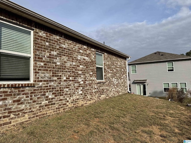 view of home's exterior with a yard