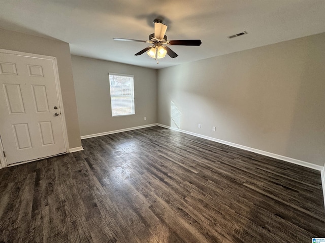 spare room with dark hardwood / wood-style floors and ceiling fan