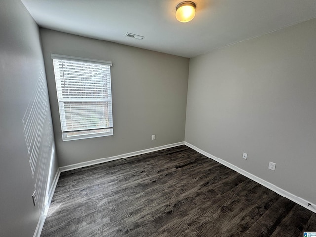 empty room featuring dark wood-type flooring