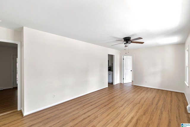 unfurnished room with ceiling fan and light wood-type flooring