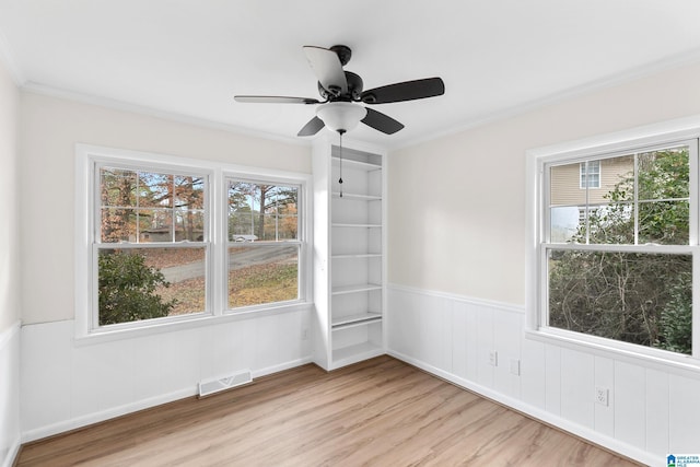 unfurnished room featuring ceiling fan, ornamental molding, and light hardwood / wood-style flooring