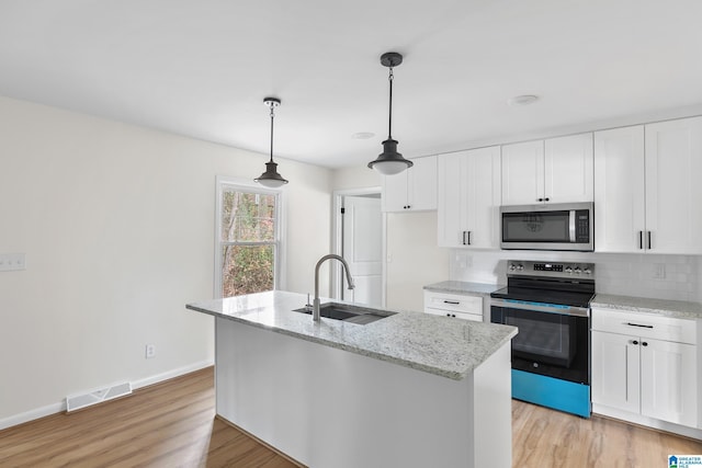 kitchen with sink, white cabinets, an island with sink, and appliances with stainless steel finishes