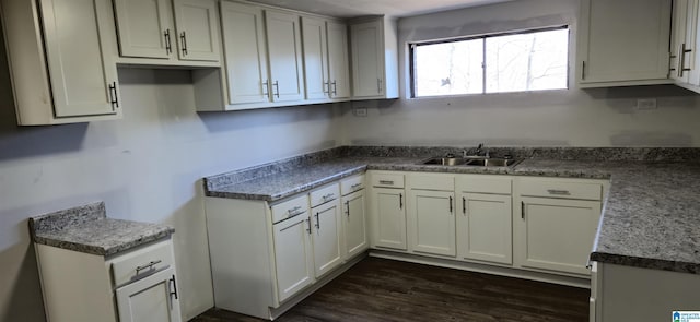 kitchen with white cabinetry, dark wood-type flooring, and sink