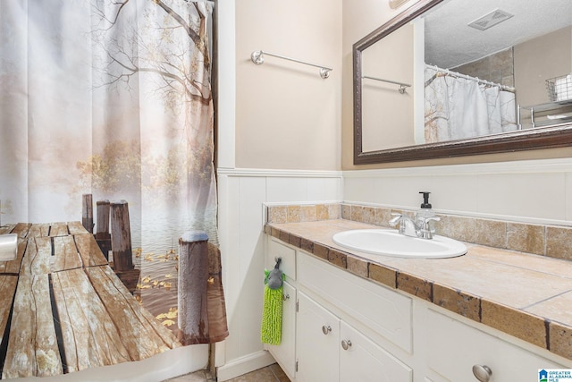 bathroom featuring vanity and a textured ceiling