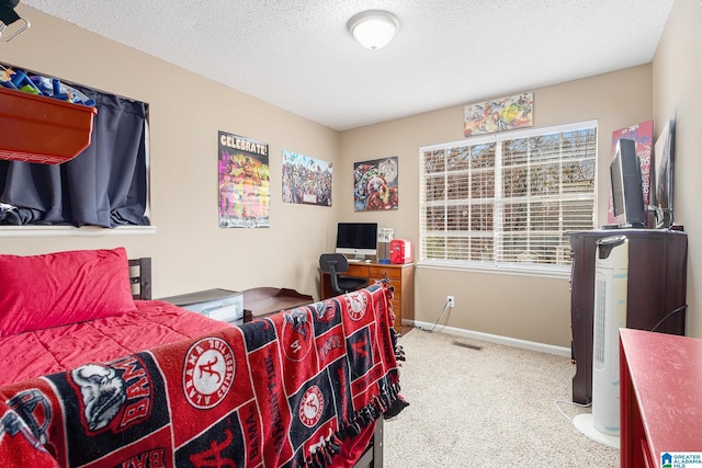 bedroom featuring carpet and a textured ceiling