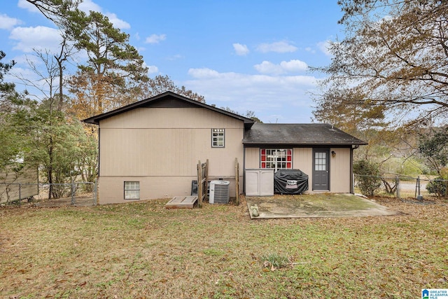 rear view of house with a yard, a patio, and cooling unit