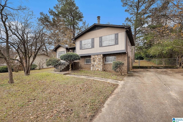 tri-level home with a front yard