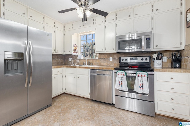 kitchen featuring white cabinets, backsplash, and stainless steel appliances