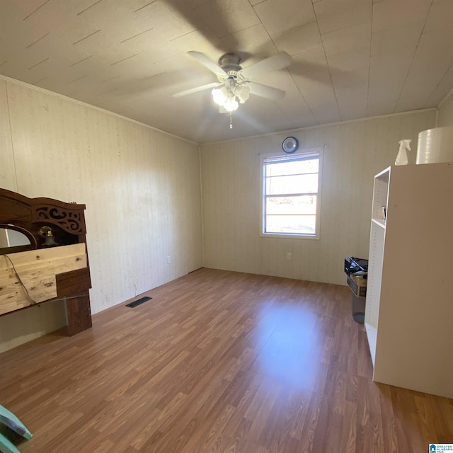 empty room featuring ceiling fan and hardwood / wood-style floors