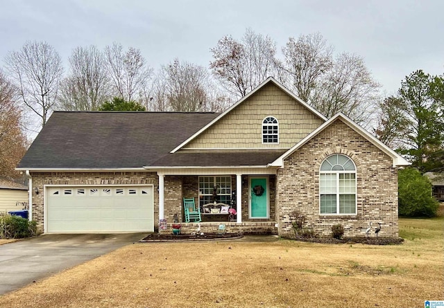 view of front of home with a porch, a garage, and a front lawn