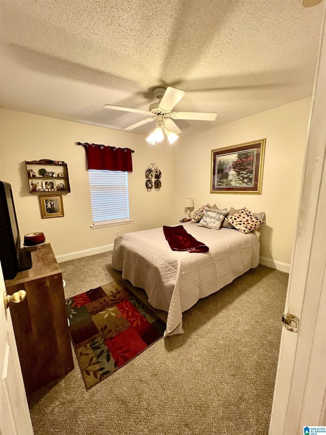 bedroom with carpet, a textured ceiling, and ceiling fan