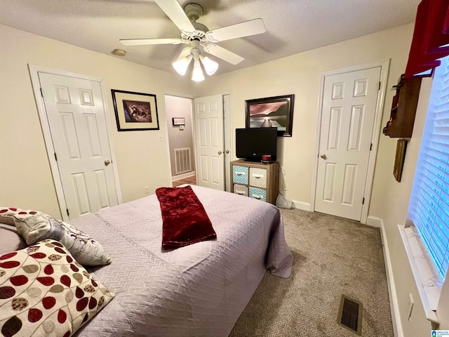 bedroom with carpet flooring, a textured ceiling, and ceiling fan