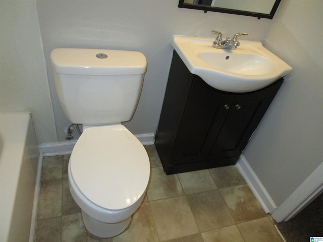 bathroom with a bathing tub, vanity, and toilet