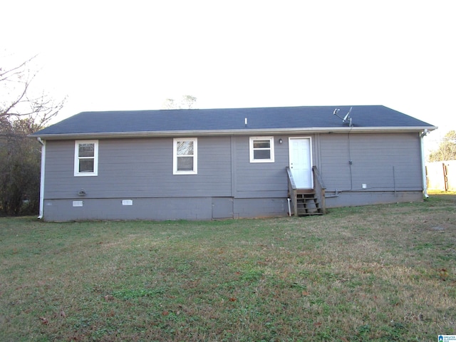 back of property featuring a yard