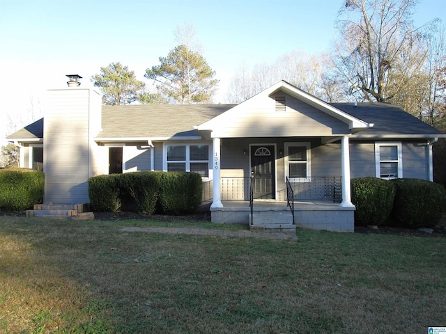 view of front facade with covered porch and a front lawn