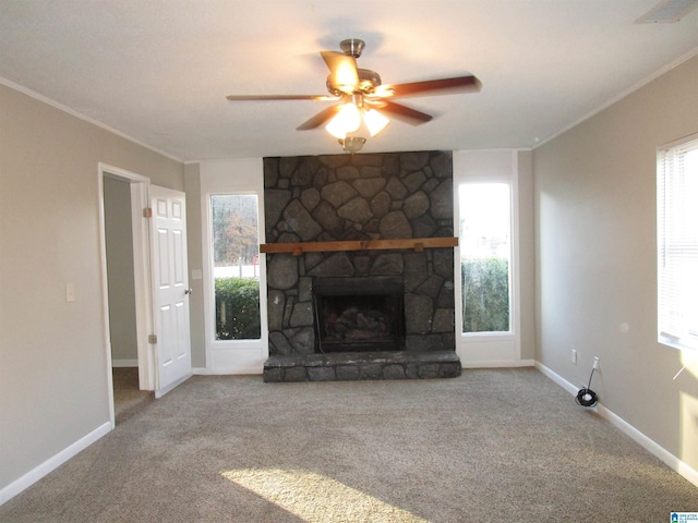 unfurnished living room featuring crown molding, a fireplace, carpet, and ceiling fan