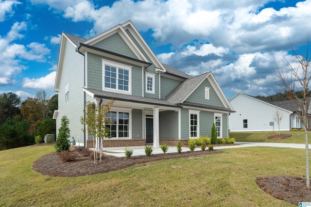 craftsman house with a porch and a front yard