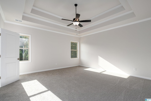 unfurnished room with light carpet, a tray ceiling, ceiling fan, and ornamental molding