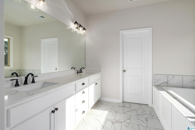 bathroom with a washtub and vanity