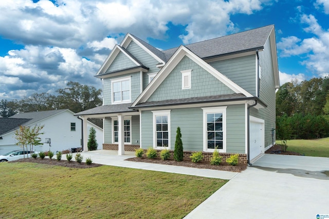 craftsman inspired home with a garage and a front lawn